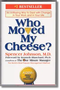 Book cover of “Who Moved My Cheese?” by Spencer Johnson, featuring bold blue title text, a cheese wedge icon, and a gold badge that reads “A Gem – Small and Valuable”; a bestselling personal development book about change and mindset.